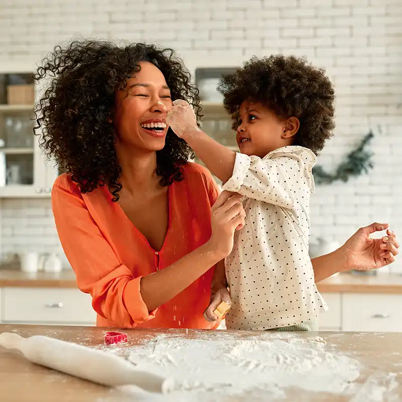 photo of a woman and her daughter baking in the kitchen